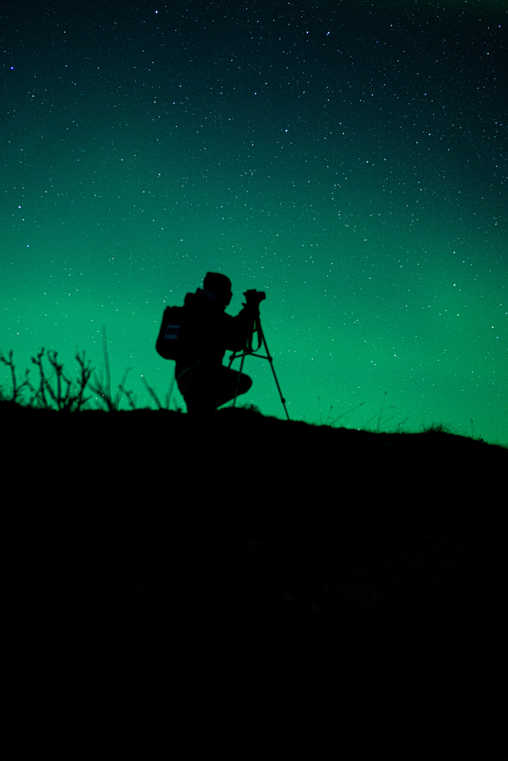 A photograhpher setting up to photograph the Aurora Borealis