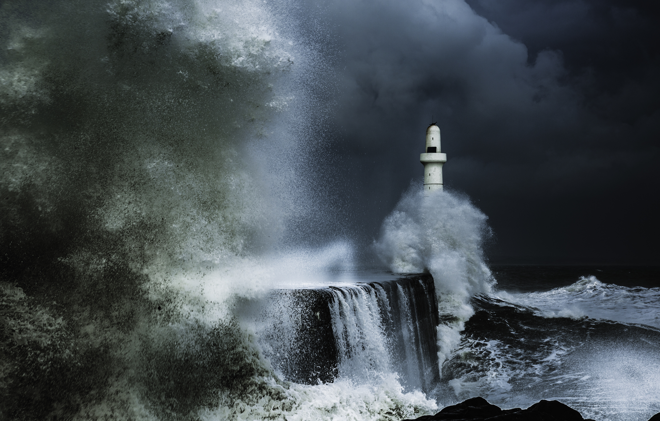 Waves crashing against a breakwater in stormy conditions