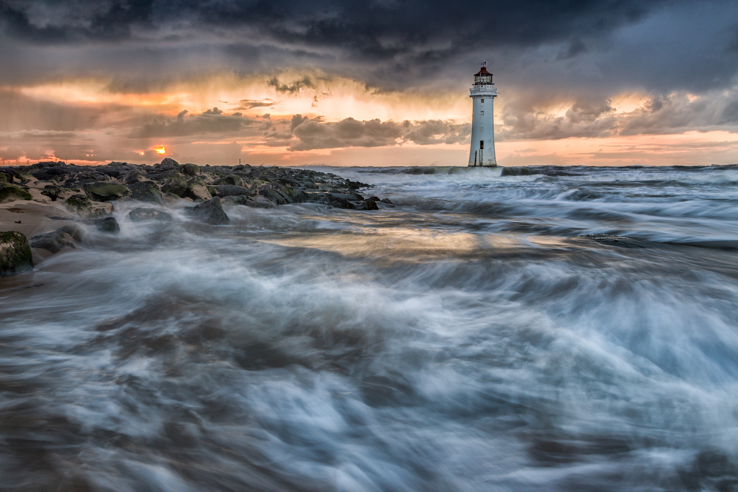 Waves crashing against the shore at New Brighton, England