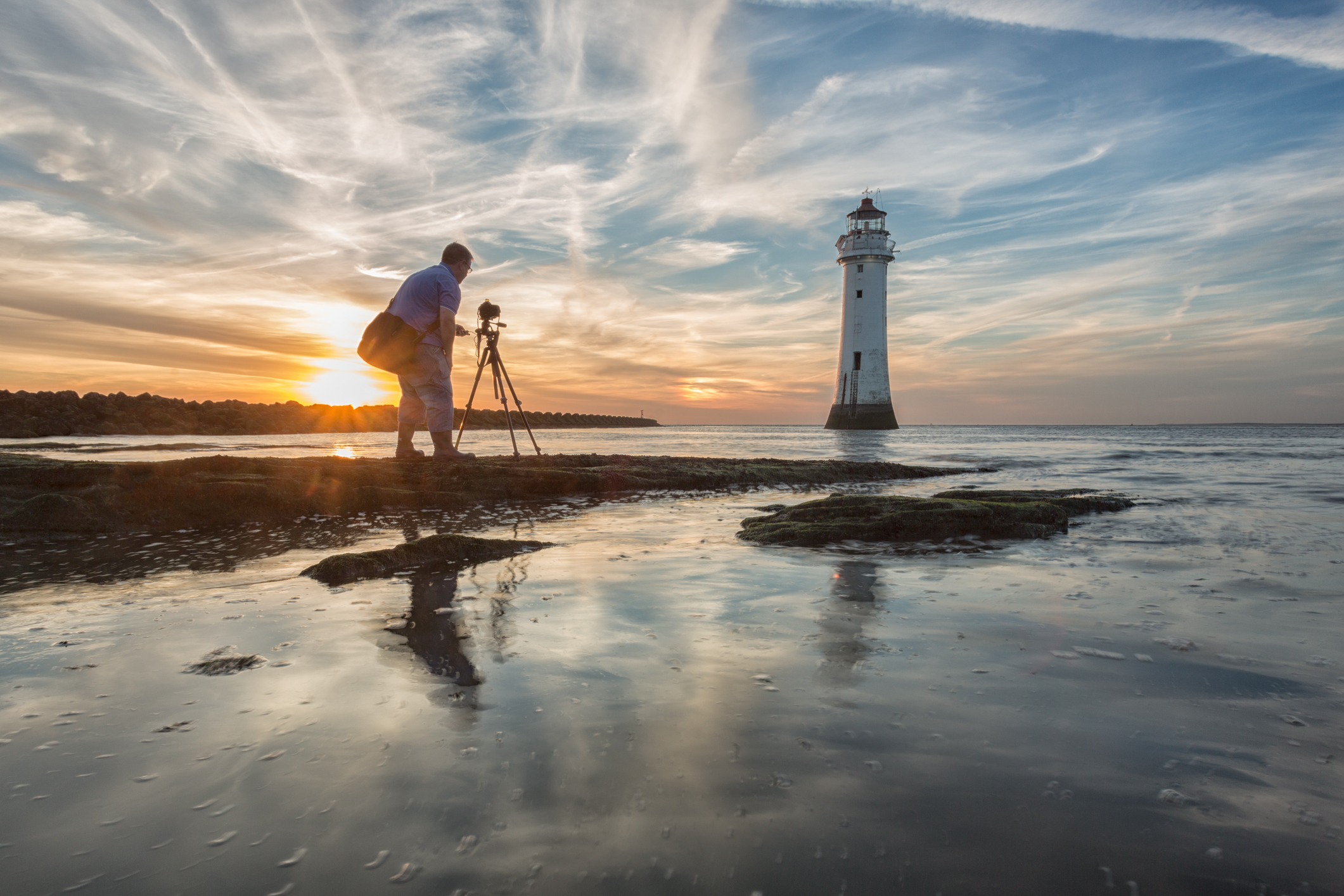 Photographer getting prepared to photograph New Brighton Lighthouse, England