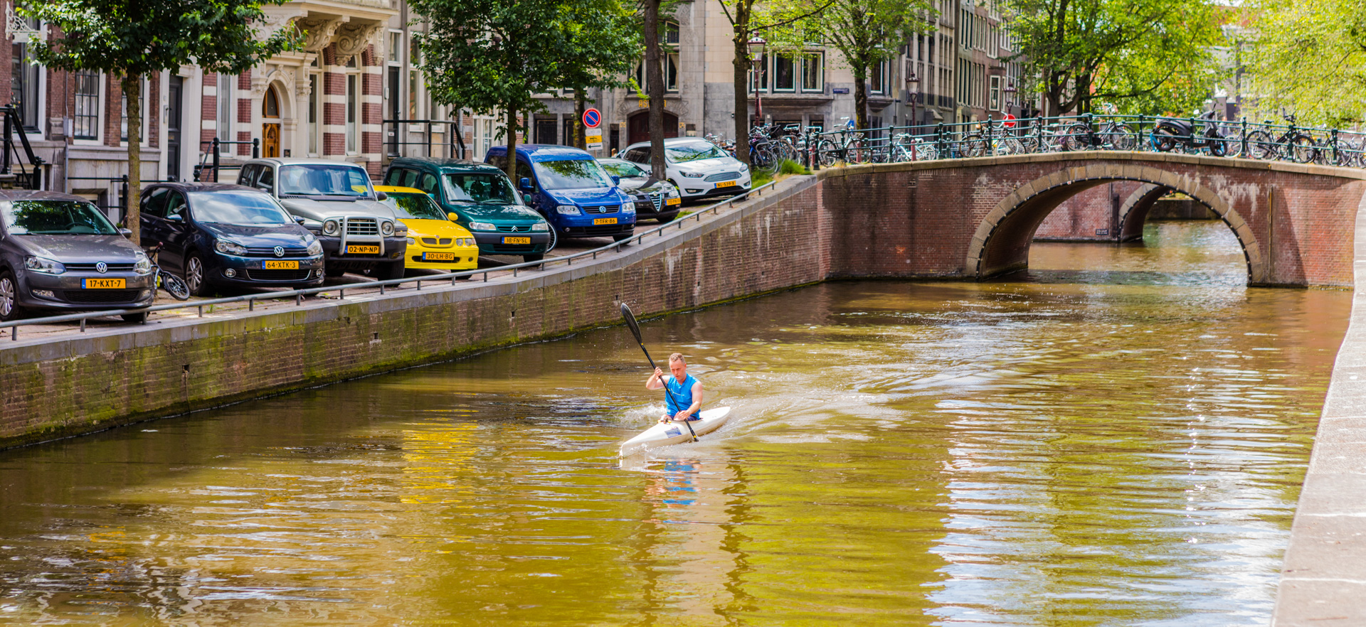 A kayaker on a canal in Amsterdam