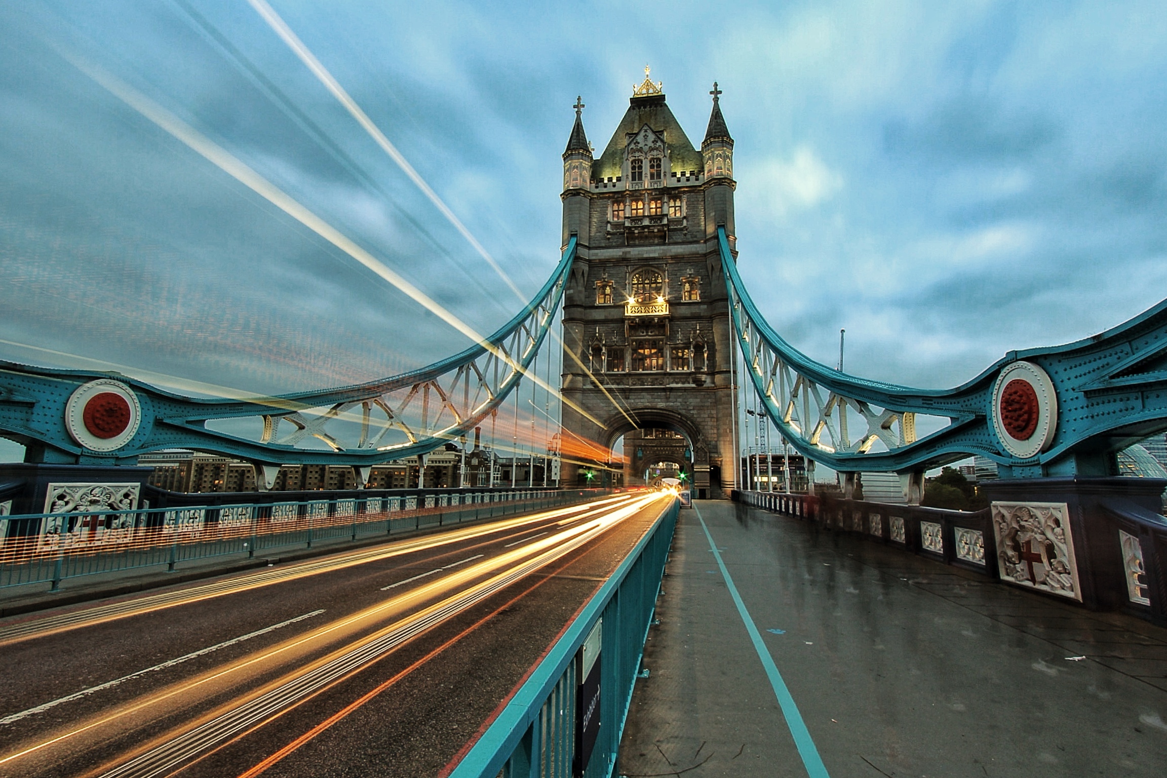 Motion blur from traffic passing through the arches of Tower Bridge, over the River Thames, London.
