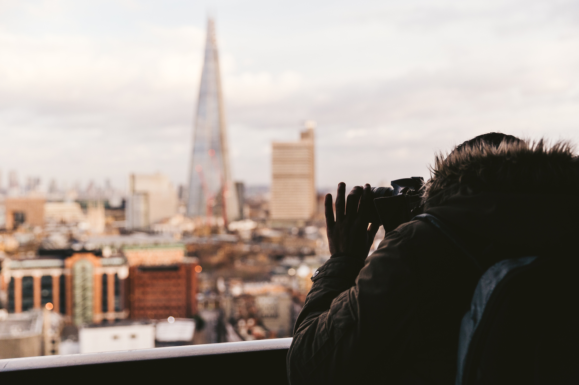 Photographer taking a picture from the viewing deck of the Tate Modern, Londonm