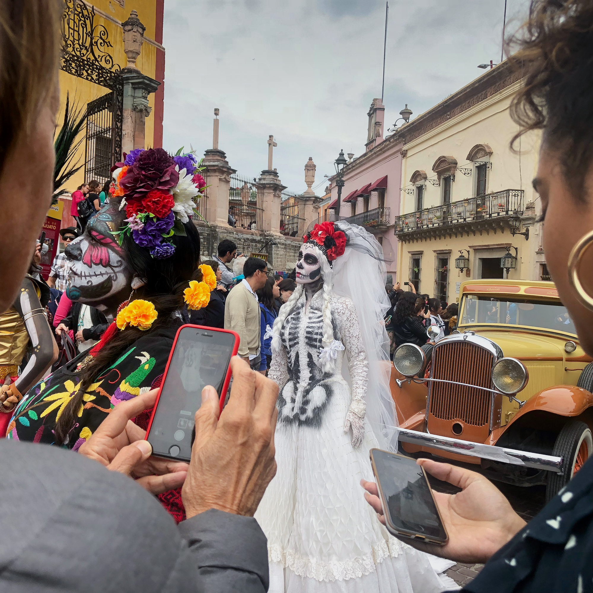 Taking a photo on a smartphone of Day of the Dead celebrations
