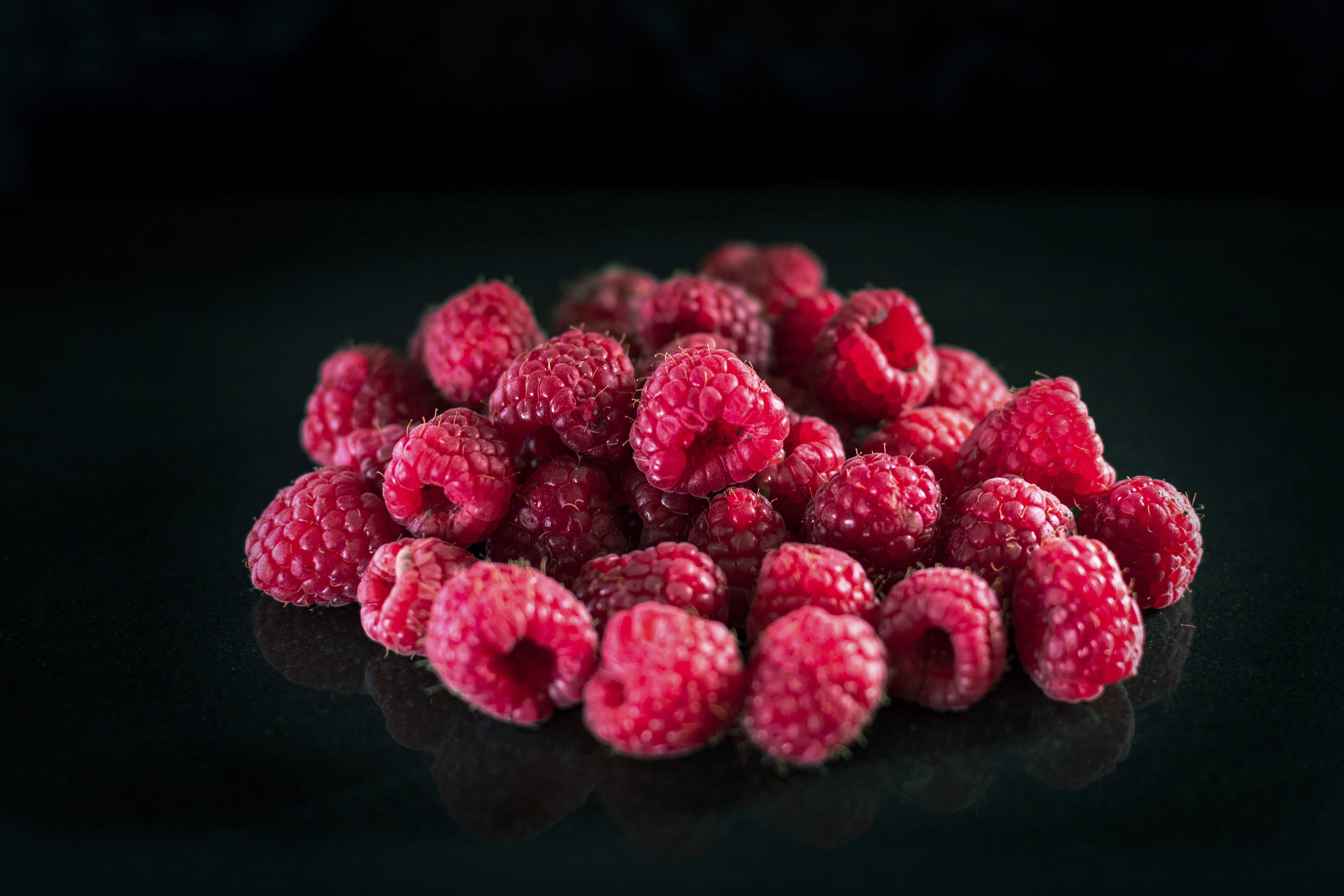 Raspberries against a black background, studio shot