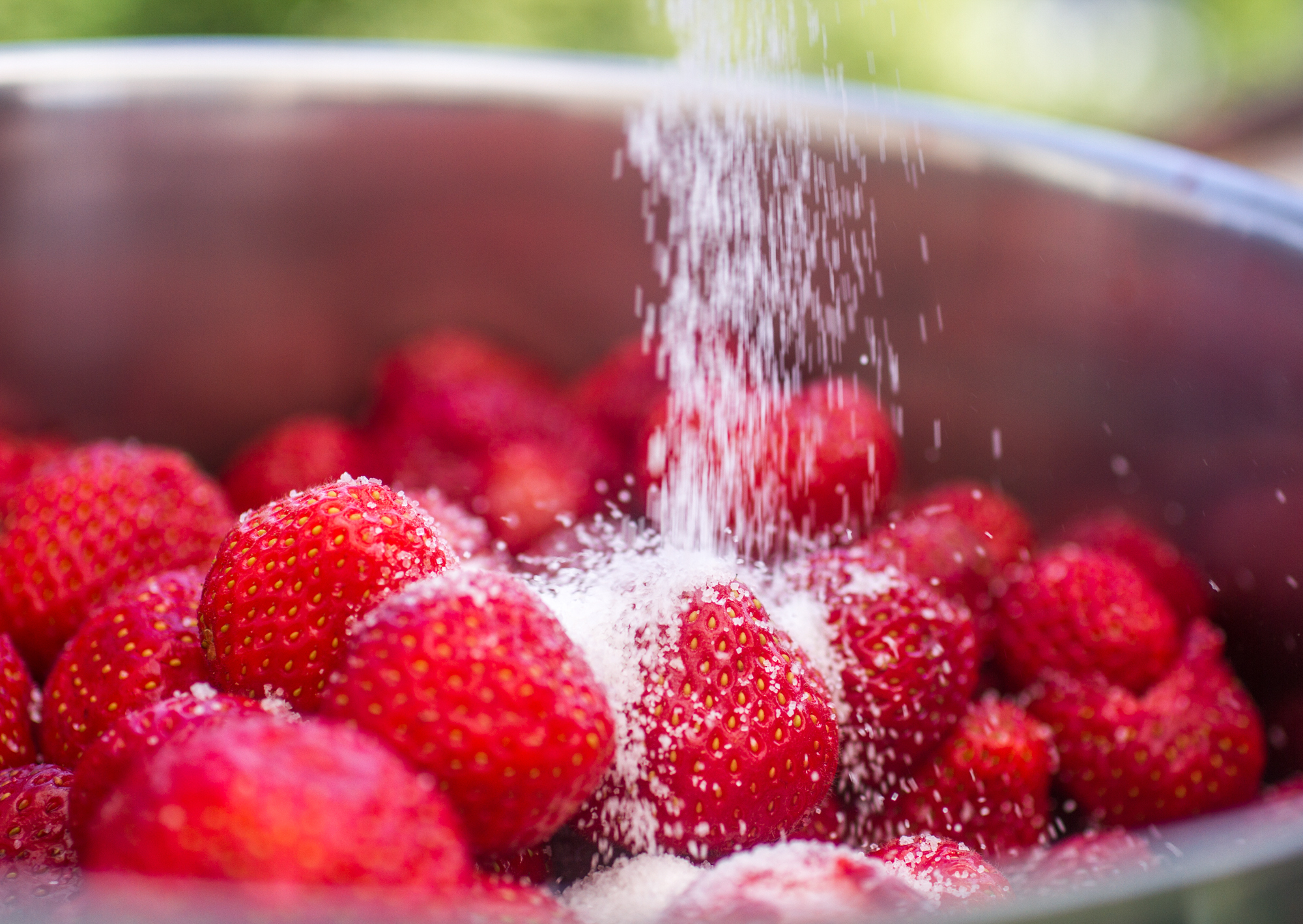 Sugar sprinkled over strawberries