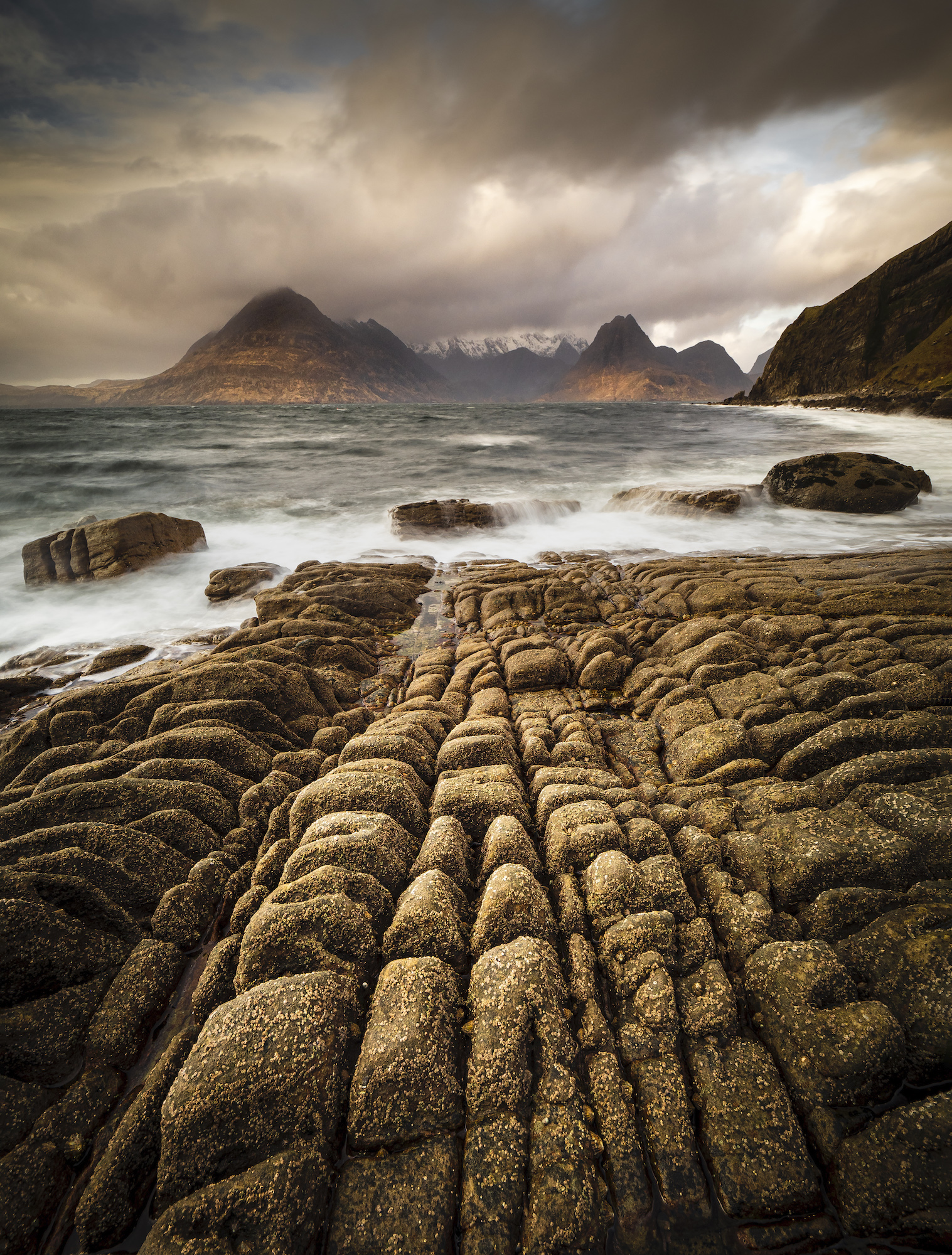 Lines in the rocks at Elgol leading to the Black Cullin mountains across the bay