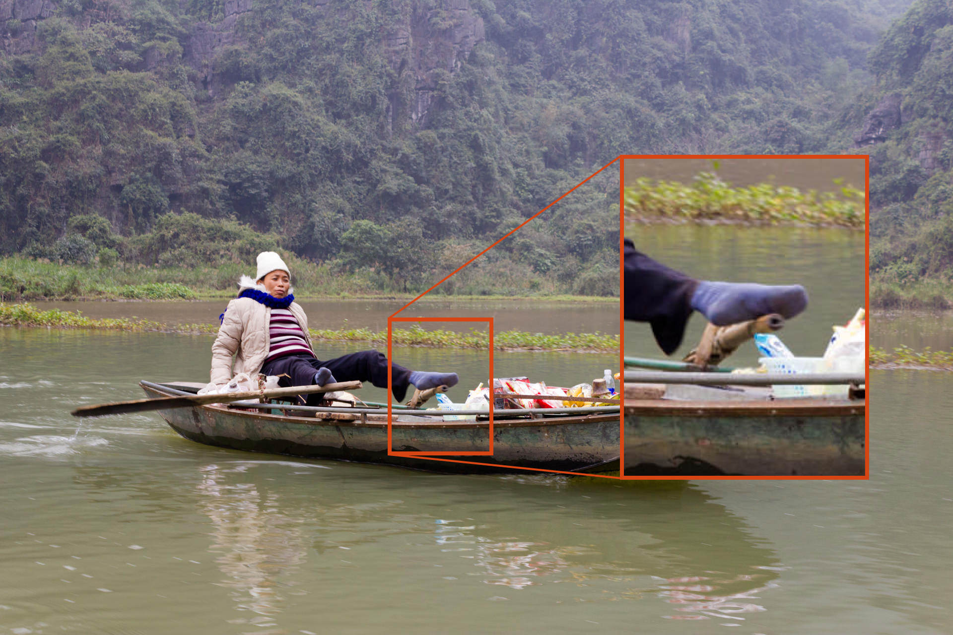 A blurred photo of a person in a boat, caused by a shutter speed too slow to capture the image