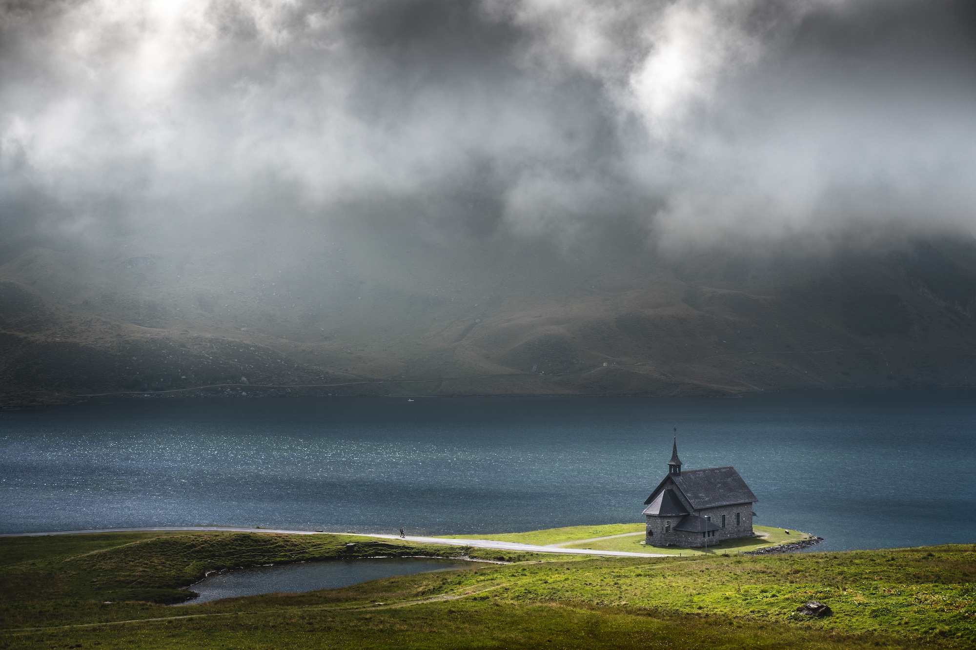 A patch of light illuminating the church at the lake, Switzerland