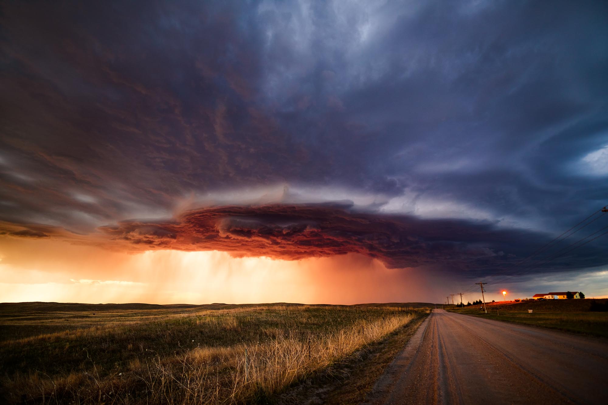 A powerful supercell thunderstorm at sunset spins across the sand hills near North Platte, Nebraska