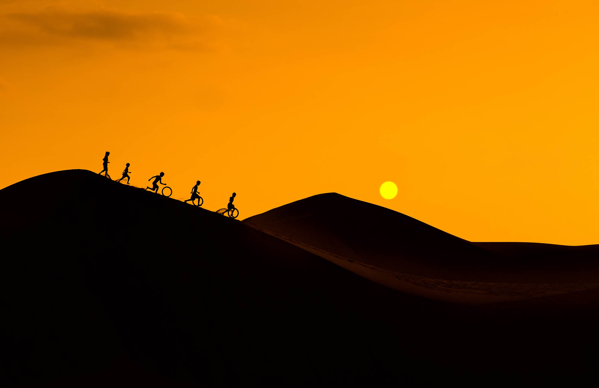 Silhouette of children playing on in the desert Vietnam