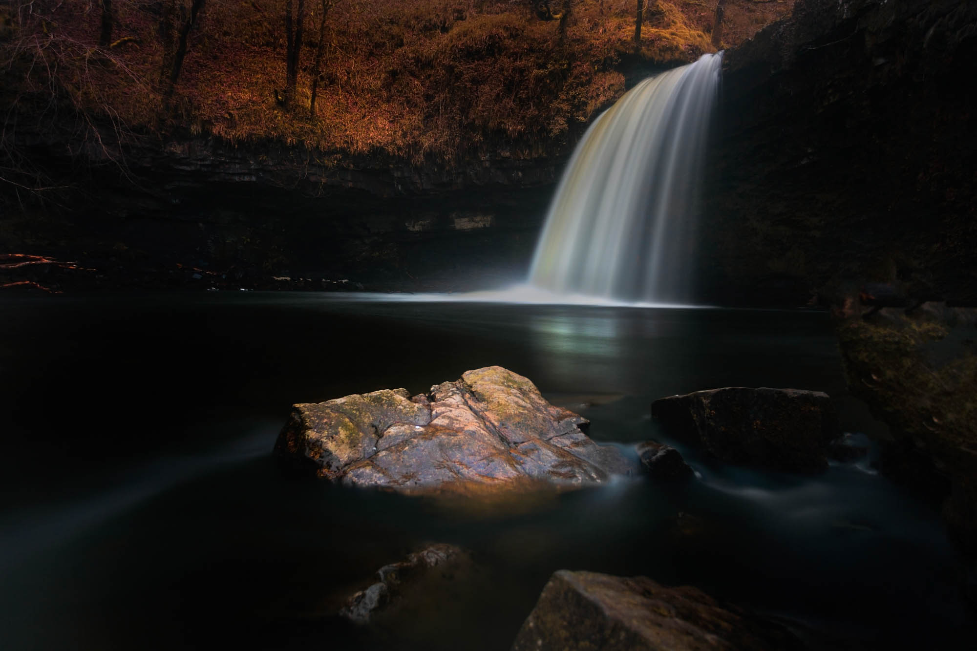 A dark and moody long exposure of the waterfall known as Lady Falls or Sgwd Gwladus on the river Afon Pyrddin near Pontneddfechan, South Wales, UK