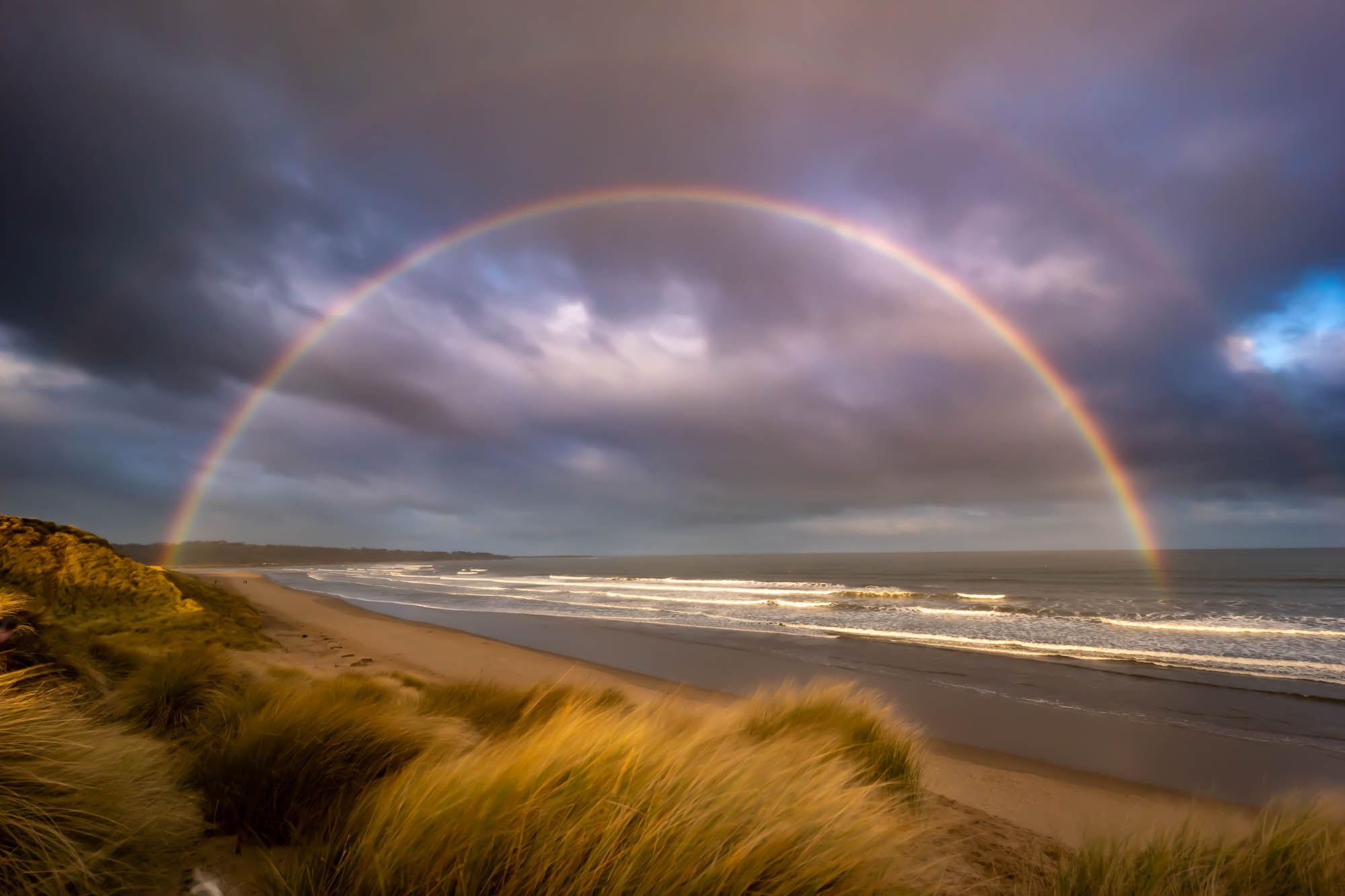 Heavy skies and a Double Rainbow on the beautiful Alnmouth Bay beach in Northumberland on New Years Day