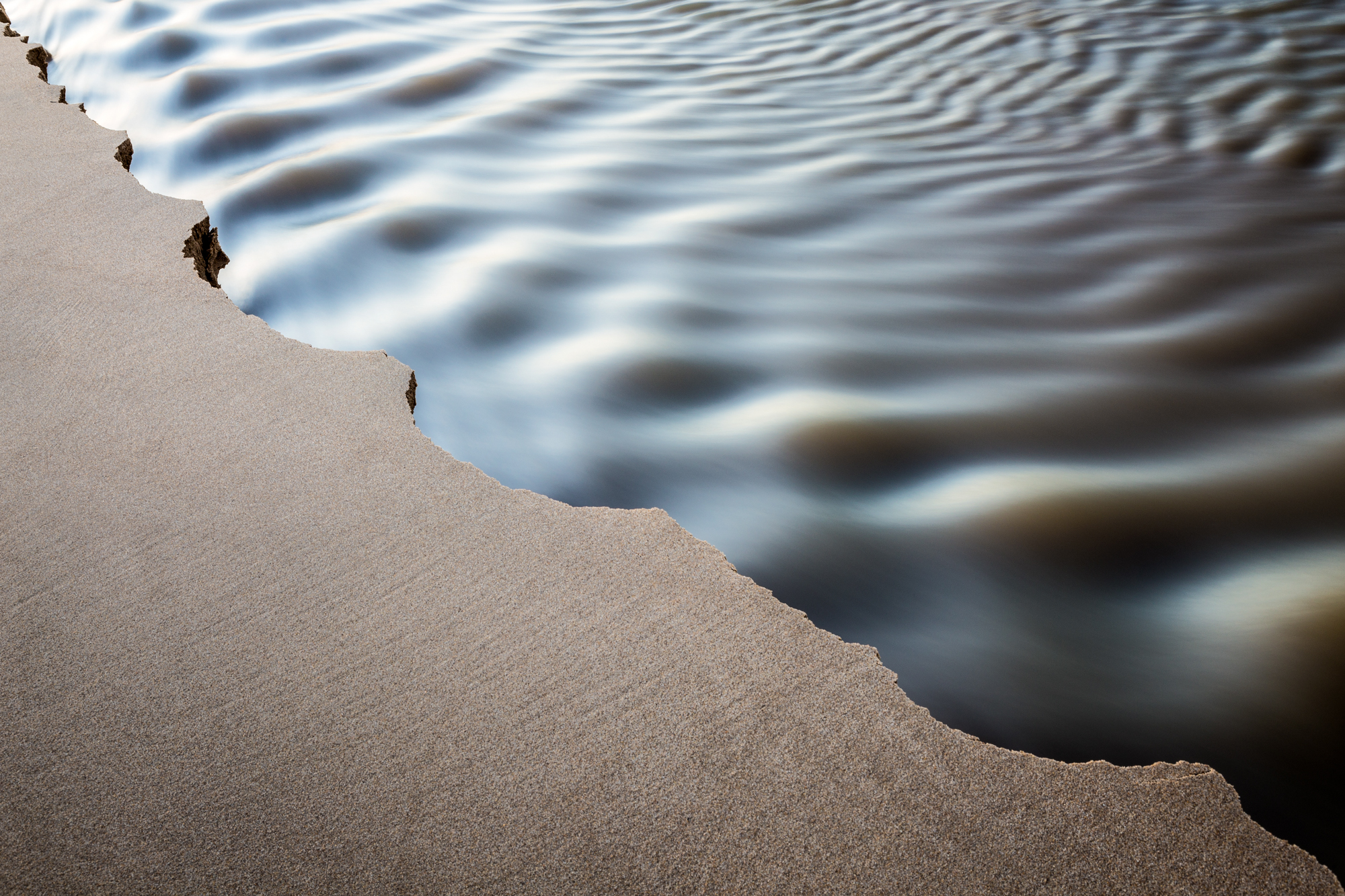 Sand and water abstract.