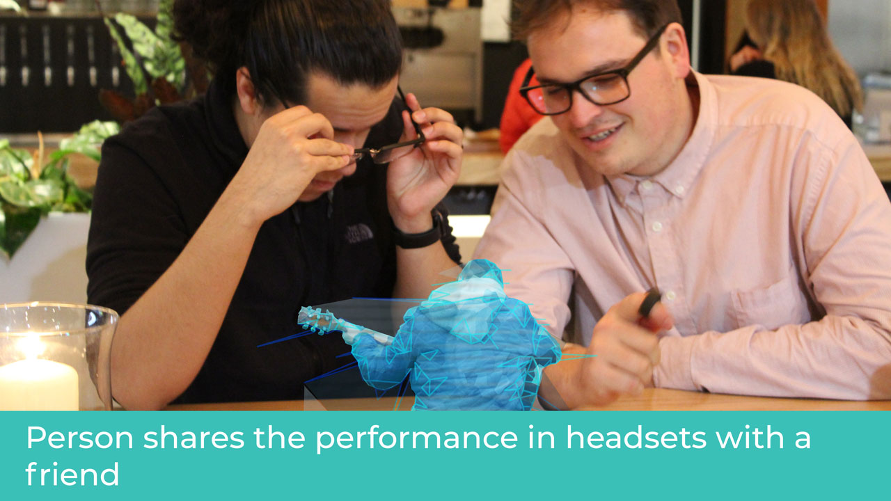 Person shares performance in headsets with a friend.
