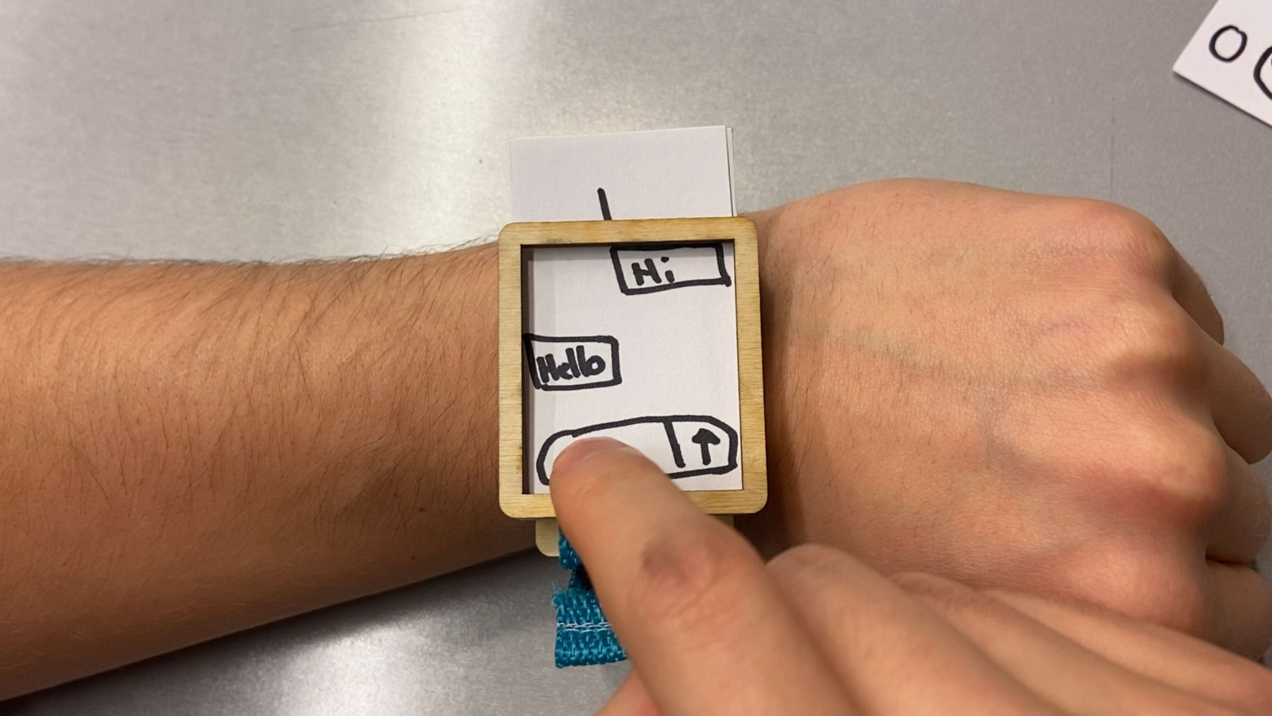 Me using a smartwatch prototype that I laser cut.