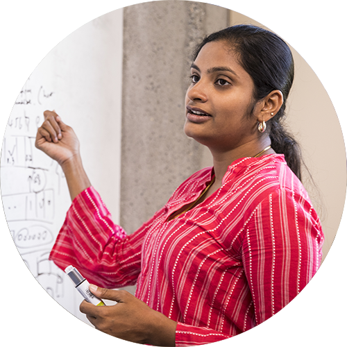 A researcher using a whiteboard talking about funding.