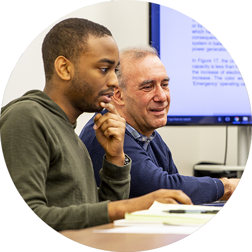 A researcher working closely with a mentor.