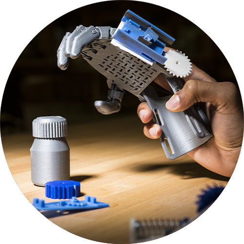 A person holding a 3D printed robotic hand that they would like to license.