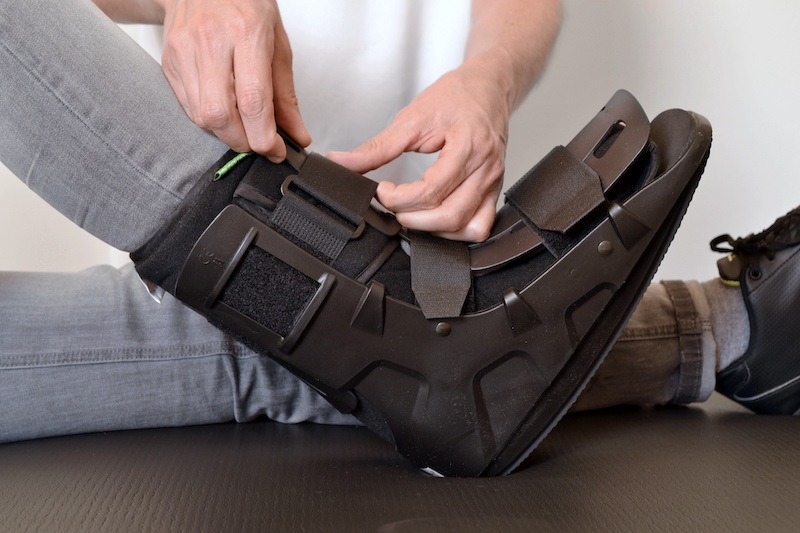 person wearing controlled ankle movement boot for foot injury