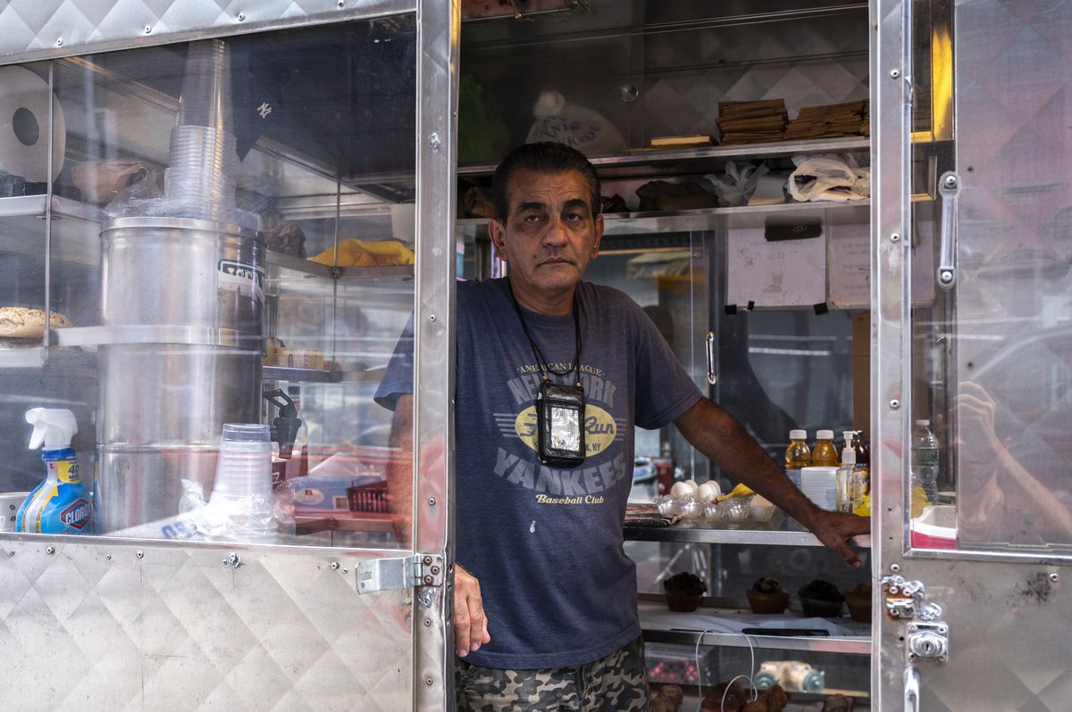 Bashir Saleh in his coffee and pastries food cart on West 43rd Street, a stone’s throw away from the Hard Rock Café.