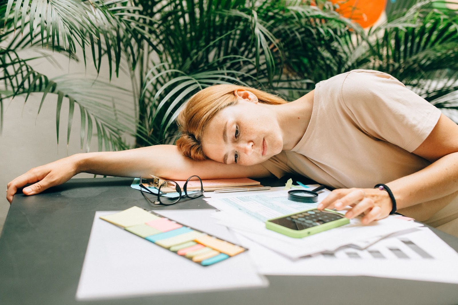 woman at desk with calculator