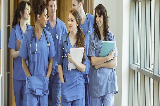A group of medical interns walking together.