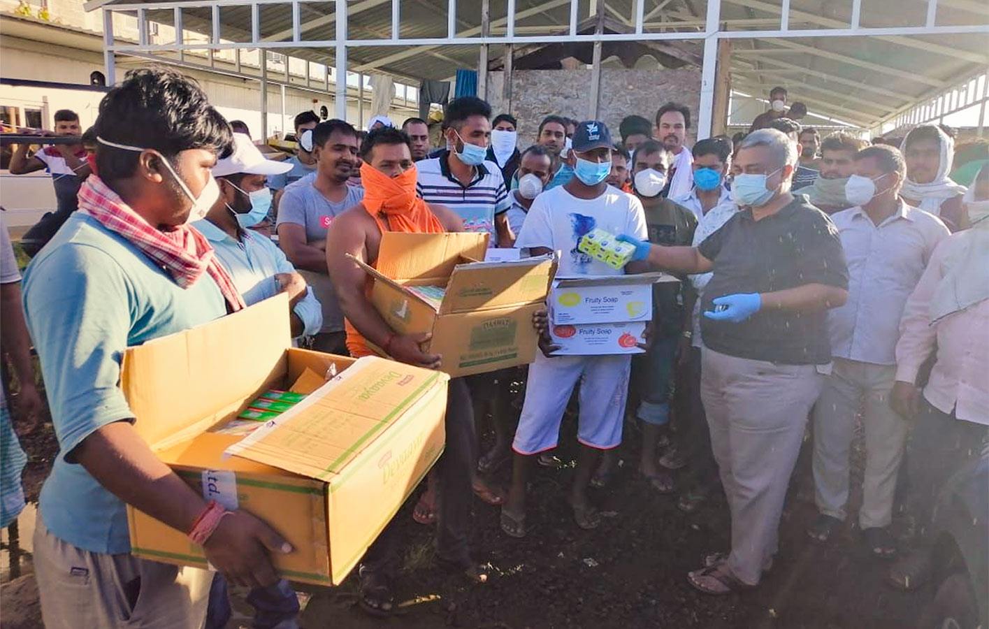 Staff handing out food in India in a public market