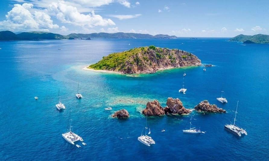 Sailing boats anchored off a remote island