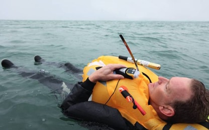 man overboard with safety vest and PLB