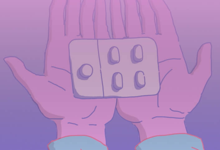 hands holding pills packet