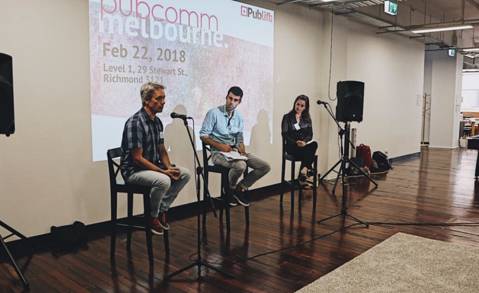 Publift CEO Colm listens to a speaker at the PubComm event in Melbourne