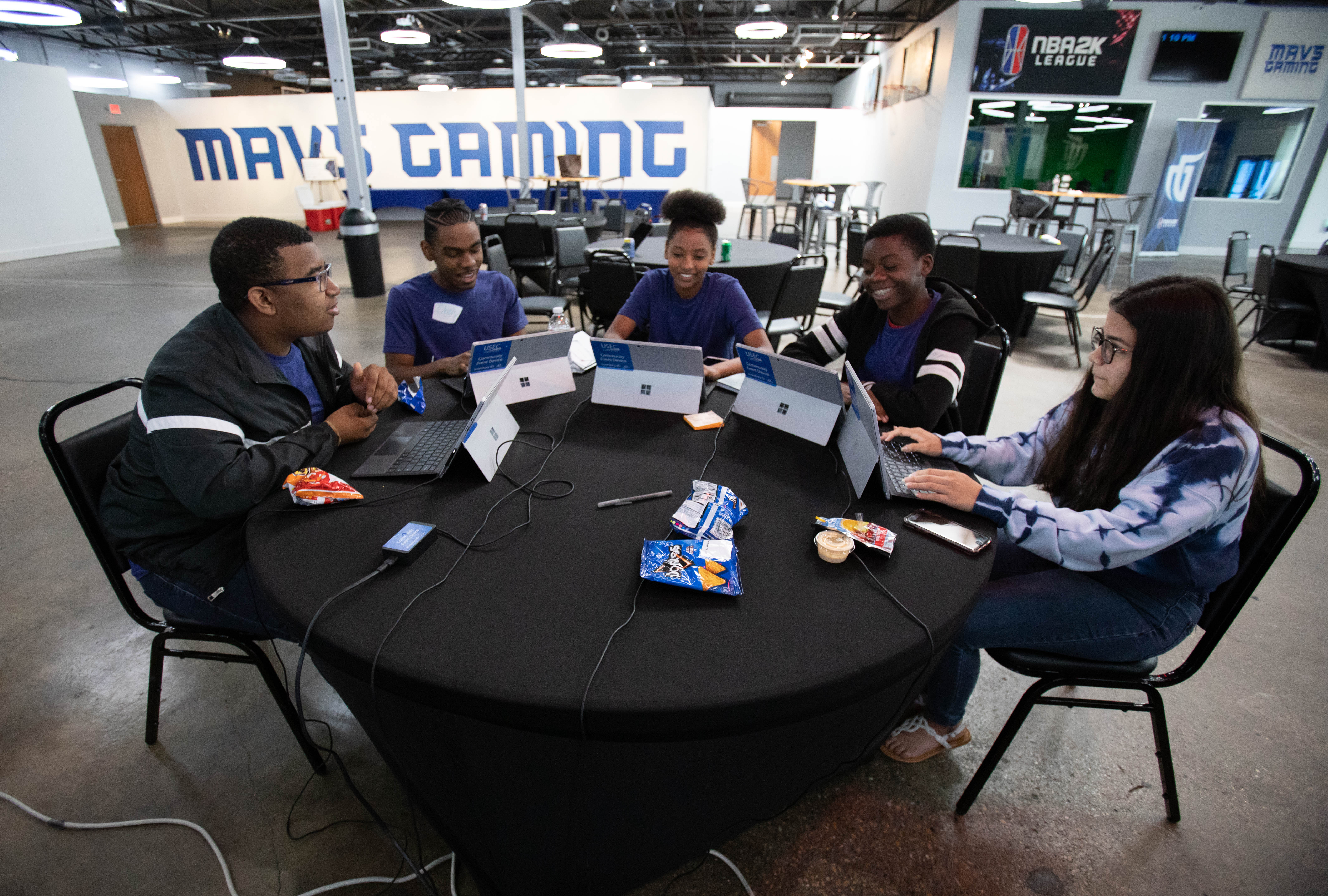 Student using computers around a table