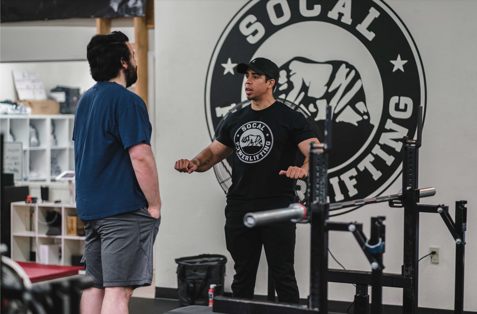 SoCal Powerlifting coach Juan Sanchez demonstrating proper bench grip for a client who asked him a question.