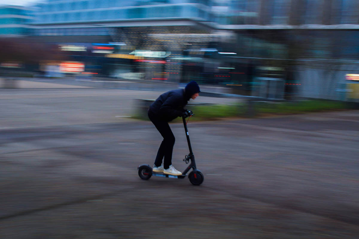 Man riding his e-scooter at high speeds. 