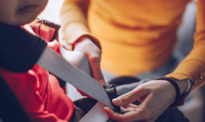 Seatbelt being put on toddler