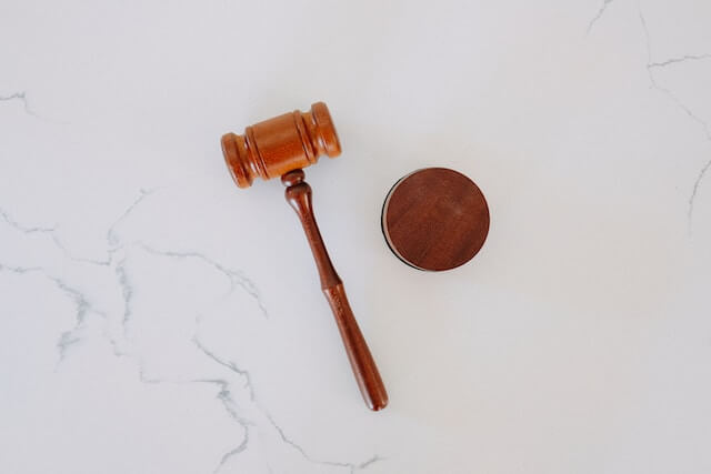 Gavel and block sitting on a white marble table 
