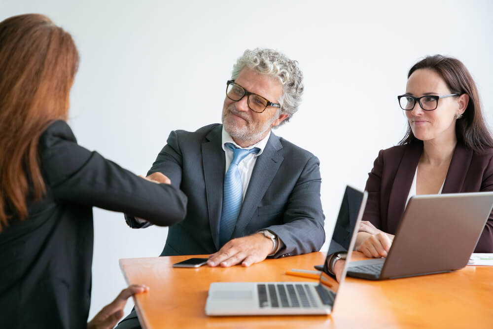 three people making a deal