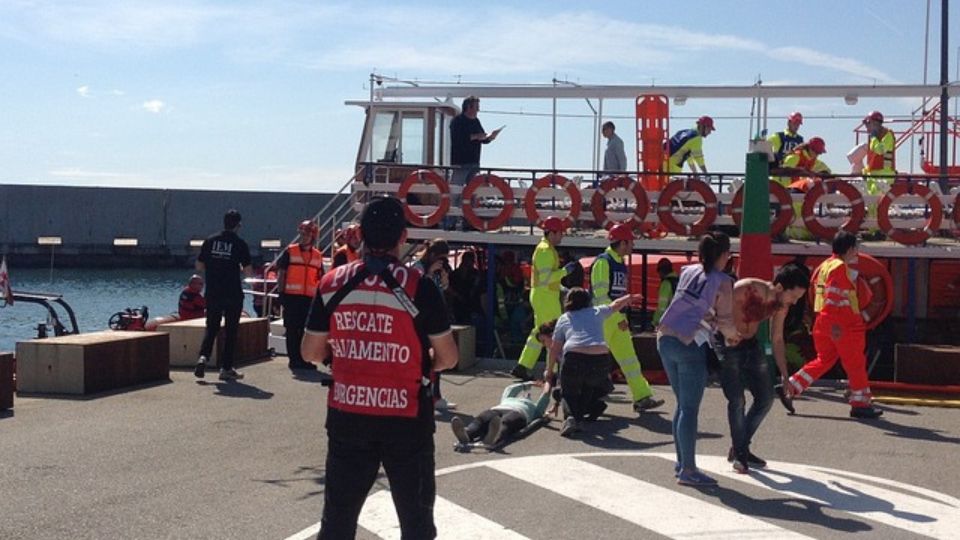 Rescuers helping injured people in a harbor