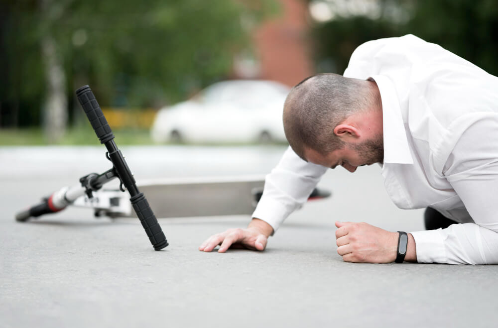 close up man wounded on the ground after drive scooter 