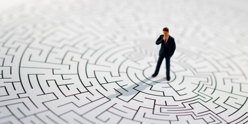Business man in the middle of a puzzle.