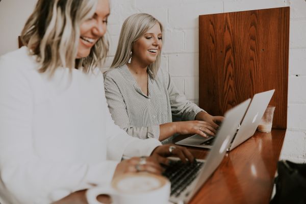 Two people working on their laptops