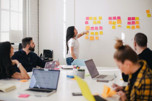 Woman putting post its on the board