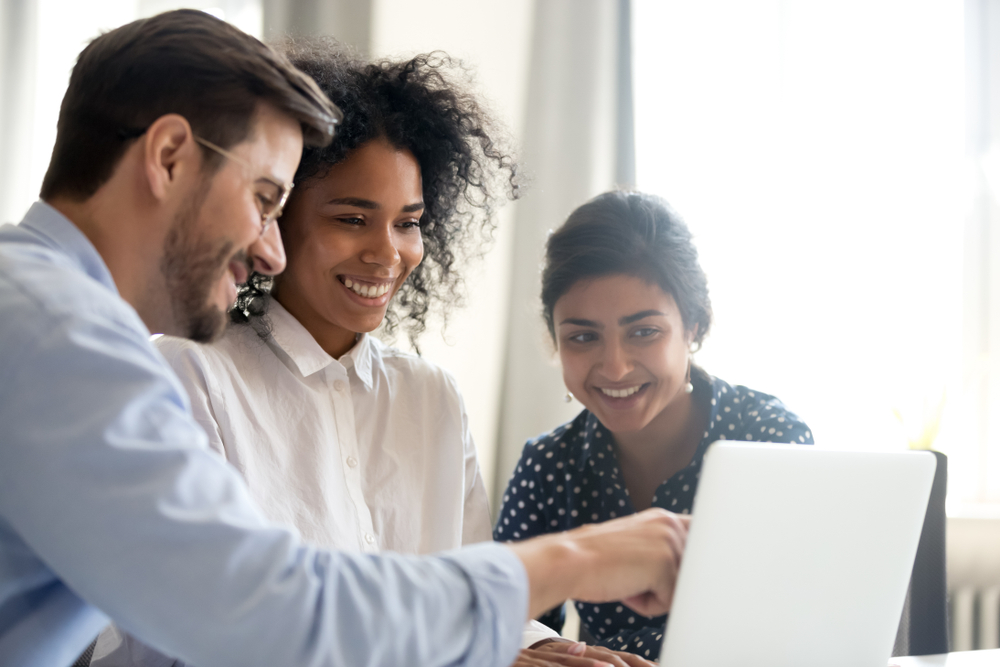 Person explaining automation to two colleagues in a business environment