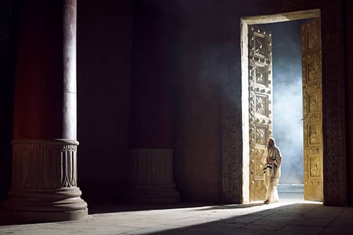 A man walking into the holy section of the temple.