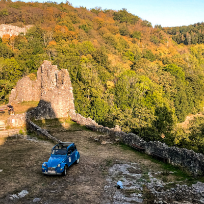 Blue Citreon 2CV on a rocky area in the Belgian countryside in spring