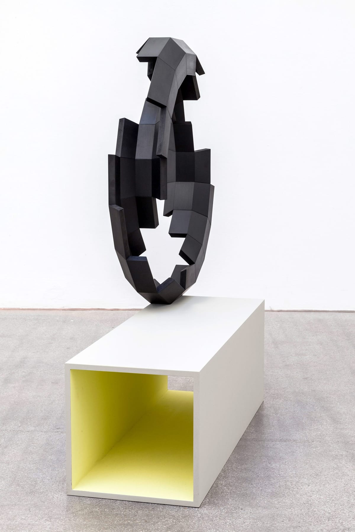 viewing room, art, munchies art club, shows a black sculpture on a white pedestal.