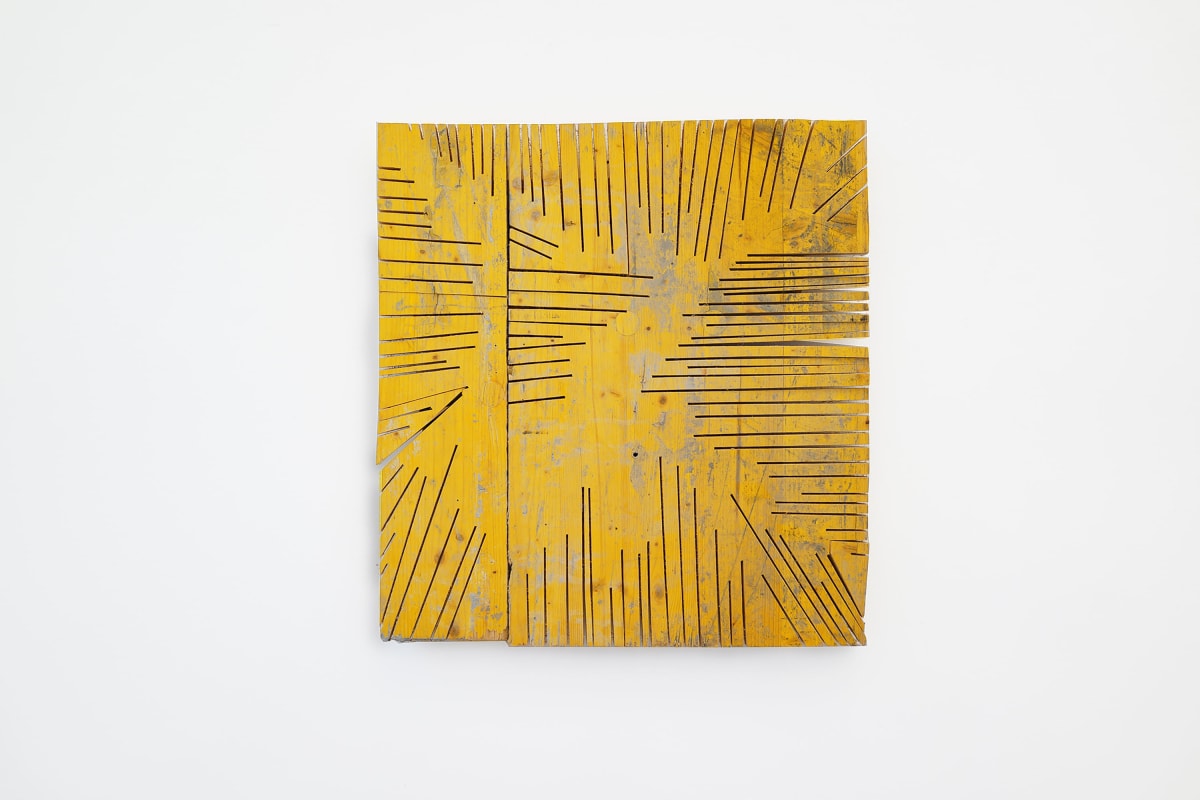 ernst koslitsch artwork depicts a yellow sqare piece of wood with deep cuts in the wood