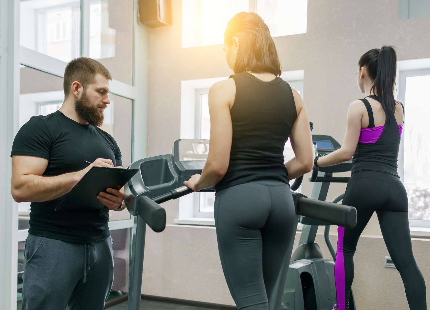 Instructor taking note of a member's specifics
