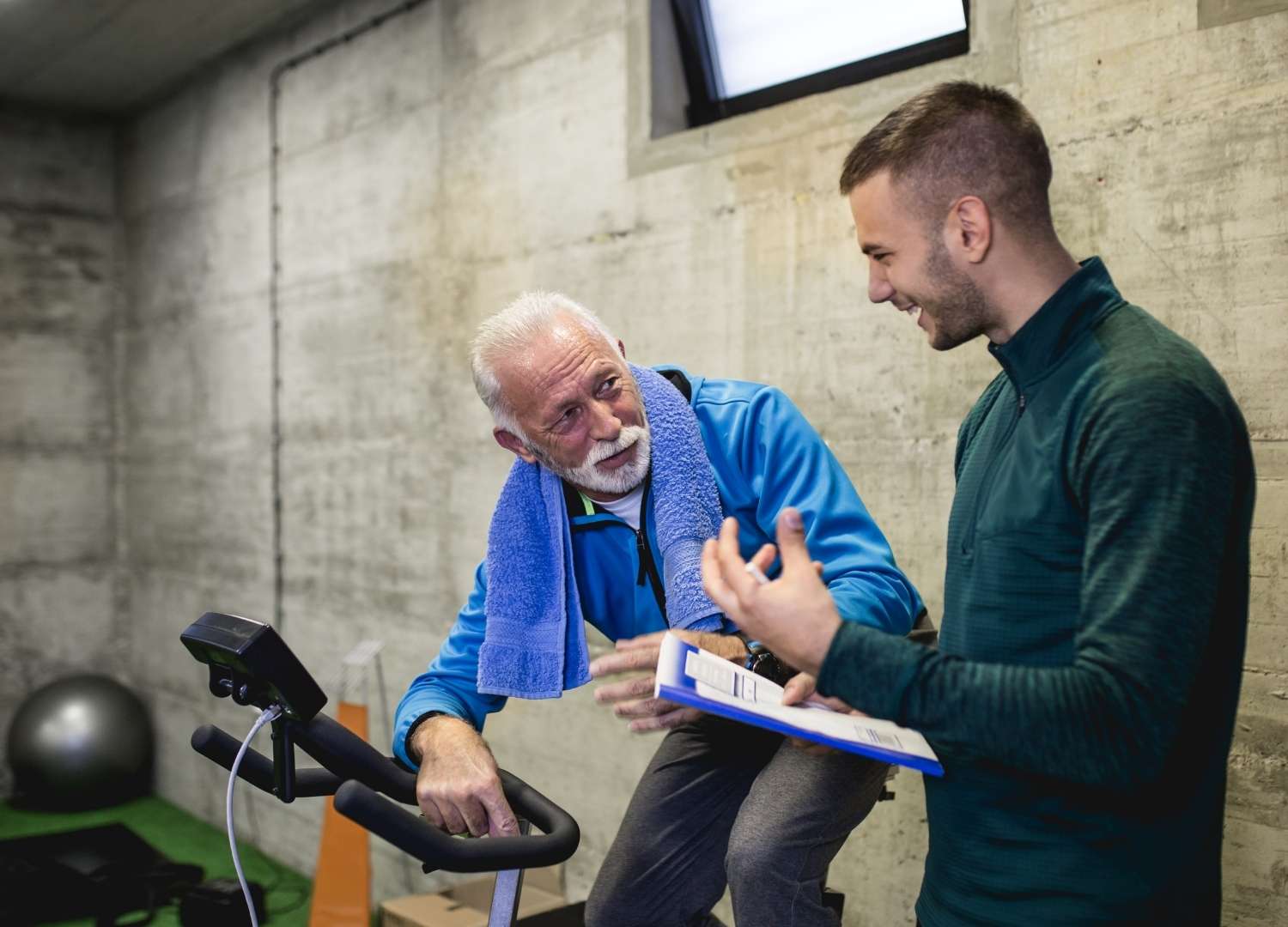 An instructor talking to an elder man